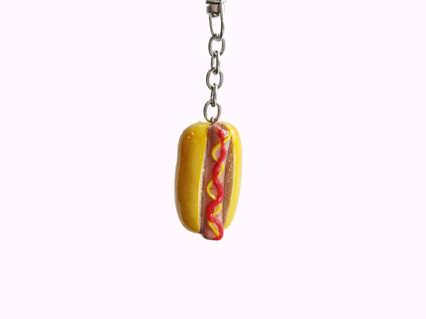 Realistic hotdog keychain. Hotdog with ketchip and mustard.